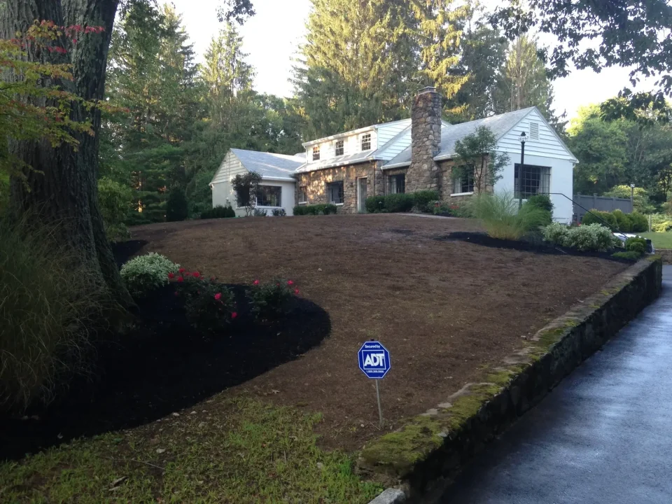 A stone house with landscaped garden
